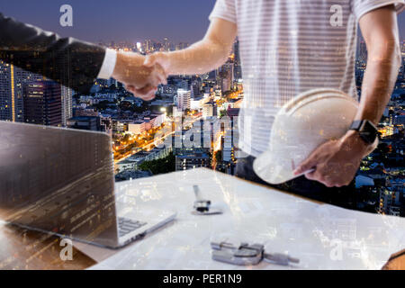 Double exposure of Businessman and Architecture hand shaking hands successful team work. Stock Photo