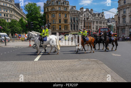 Trafalgar Square, London, UK - june 8, 2018:  Six mounted police officers, riding in formation towards Trafalgar Square. Stock Photo