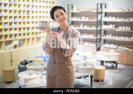 Young potter making pottery in studio Stock Photo