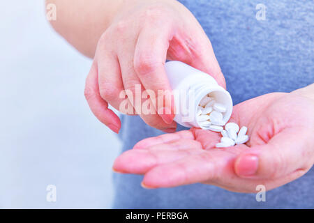 Holding medicine bottle and pour in hand ,with clipping path Stock Photo
