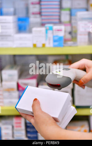 Pharmacist scanning barcode of medicine drug in a pharmacy drugstore. Stock Photo