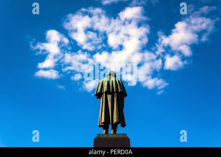 Sculpture of the man and sky clouds Stock Photo