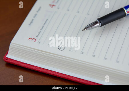 Closeup of notepad for agenda kept on table in empty corporate conference room before business meeting Stock Photo