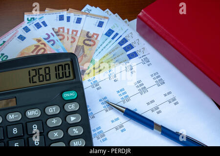 A finance still life with euros banknotes, calculator and pen. Stock Photo