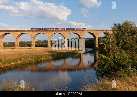 A Northern rail Leeds to Knareborough train crossing Wharfedale viaduct (River Wharf)  formed of a class 150 sprinter + 144 pacer Stock Photo