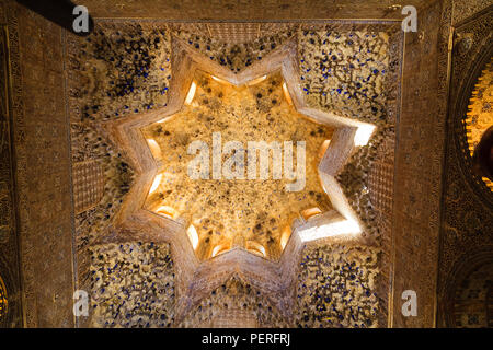 Looking up into ornate and decorative islamic architecture ceiling at the Alhambra Palace in Granada Spain Stock Photo