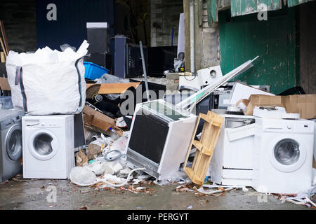 Washing machines for recycling storage dumped with waste and rubbish to help reduce pollution Stock Photo