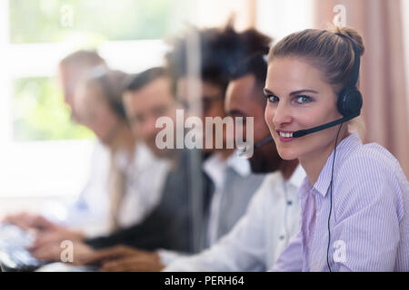 Portrait Of A Happy Young Female Customer Service Executive Stock Photo
