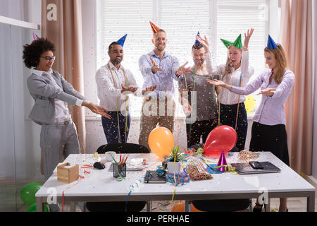Group Of Young Businesspeople Celebrating New Year Party In Office Stock Photo