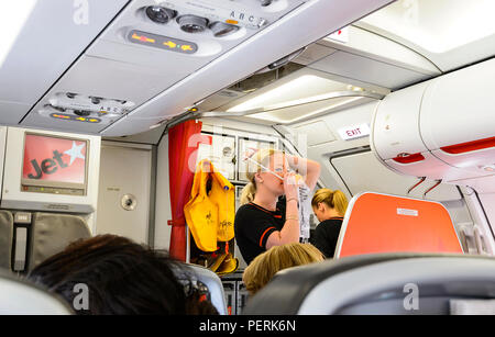 Jetstar in-flight safety demonstration by attractive blonde stewardess, Australia Stock Photo