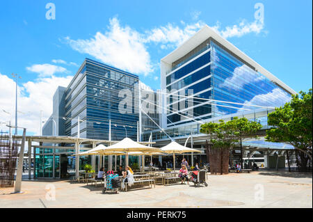 Parasols and people seated at tables outside Sydney Kingsford-Smith International Airport, New South Wales, NSW, Australia Stock Photo