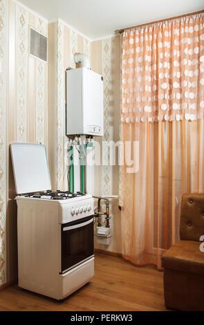 new modern white gas boiler and stove in the kitchen Stock Photo