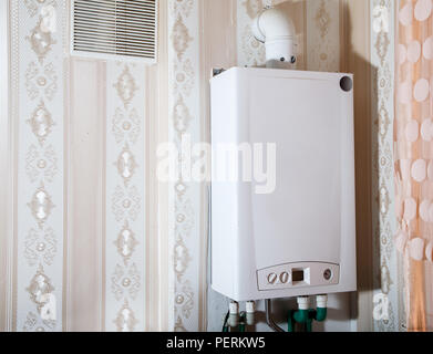 new modern white gas boiler on the wall  in the kitchen closeup Stock Photo
