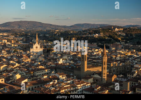 Florence, Italy - March 23, 2018: Evening light illuminates the cityscape of Florence, including the Bargello Tower and Basilica di Santa Croce church Stock Photo