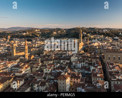 Florence, Italy - March 23, 2018: Evening light illuminates the cityscape of Florence, including the towers of the Bargello and Palazzo Vecchio, with 