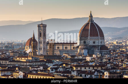 Florence, Italy - March 22, 2018: Landmarks including the Duomo cathedral stand in the Renaissance cityscape of Florence, with the hills of Monteferra