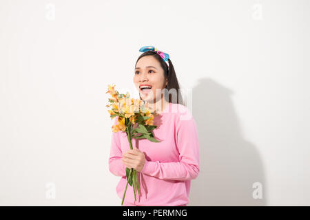 Lifestyle leisure international women's day concept. Close up portrait of lovely cute adorable excited delightful attractive woman holding flowers iso Stock Photo