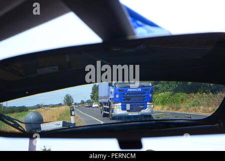 lorry reflected in car rear view mirror united kingdom Stock Photo