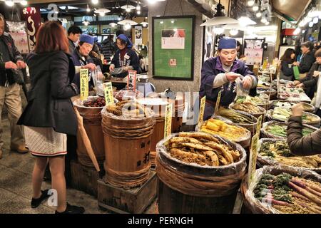 KYOTO, JAPAN - NOVEMBER 27, 2016: People shop at Nishiki Market in Kyoto, Japan. Nishiki is a popular traditional food market in Kyoto. Stock Photo