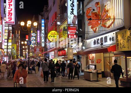 OSAKA, JAPAN - NOVEMBER 21, 2016: People visit night Dotonbori street in Osaka, Japan. Dotonbori is the main entertainment area of Osaka. Stock Photo