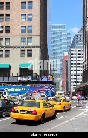 NEW YORK - JULY 6: People ride yellow taxi cab on July 6, 2013 in New York. As of 2012 there were 13,237 yellow taxi cabs registered in New York City. Stock Photo