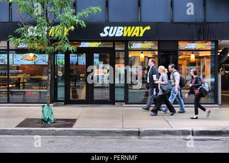 CHICAGO, USA - JUNE 26, 2013: People walk past Subway sandwich store in Chicago. Subway is one of fastest growing restaurant franchises with 39,747 re Stock Photo