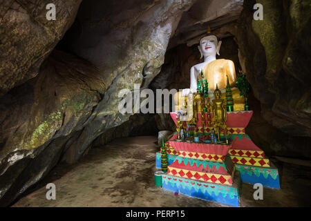 Several Buddha statues on altar inside the Tham Hoi Cave near Vang Vieng, Vientiane Province, Laos. Stock Photo