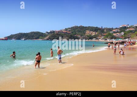 BUZIOS, BRAZIL - OCTOBER 16, 2014: People visit Joao Fernando beach in Buzios, state of Rio de Janeiro in Brazil. Brazil had 5.17 million visitors in  Stock Photo