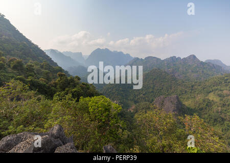 Scenic view of lush mountains and hills near Vang Vieng in Laos on a sunny day. Stock Photo