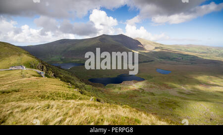 Brandon Mountain rises above the lakes of the Owenmore Valley forming the spectacular view from the summit of the Connor Pass through the mountains of
