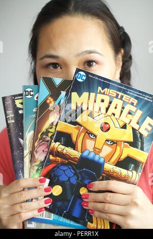 asian girl reading comic books Stock Photo