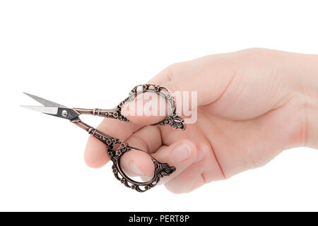 Female hand holds a pair of scissors, isolated on white background Stock Photo