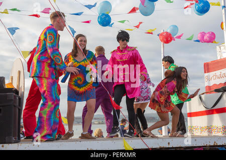 Crowds flock to watch the Weymouth carnival, on  a beautiful warm summers day. Stock Photo