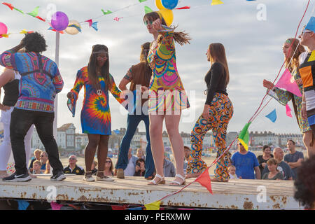 Crowds flock to watch the Weymouth carnival, on  a beautiful warm summers day. Stock Photo