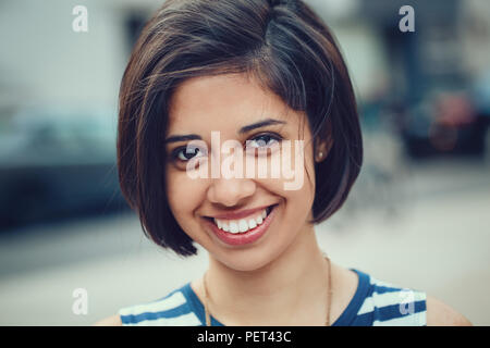https://l450v.alamy.com/450v/pet43c/closeup-portrait-of-beautiful-smiling-young-latin-hispanic-girl-woman-with-short-dark-black-hair-bob-black-eyes-outside-looking-in-camera-toned-wit-pet43c.jpg