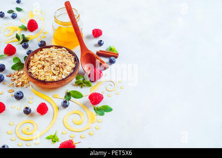 Homemade cosmetic with oatmeal and honey concept. Body scrub, peeling and spa care scene with honey swirls and spices. Copy space Stock Photo