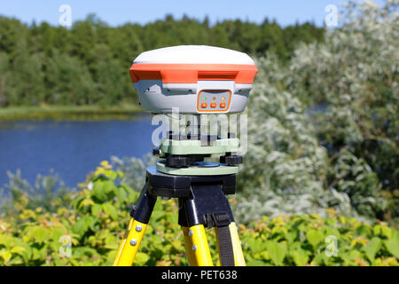 GNSS-geodetic receiver mounted on a tripod. Practical application in the field for working in networks of permanently operating base stations Stock Photo