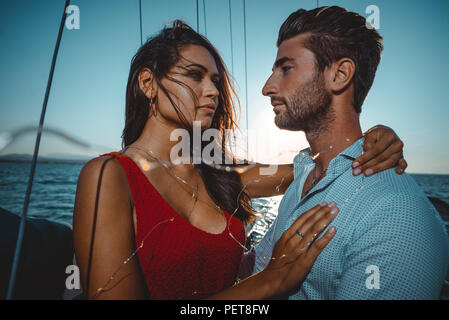happy couple taking a romantic cruise on the sail boat Stock Photo