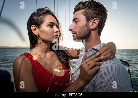 happy couple taking a romantic cruise on the sail boat Stock Photo