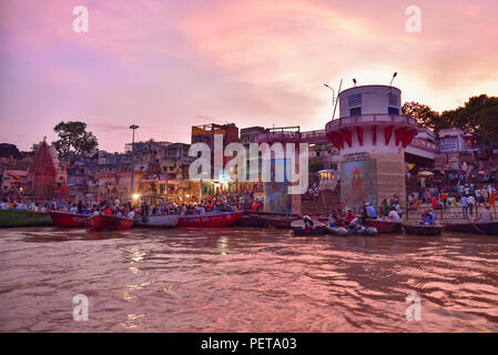 Indian people and tourists on boats at Dashashwamedh Ghat on Ganges river at evening Stock Photo