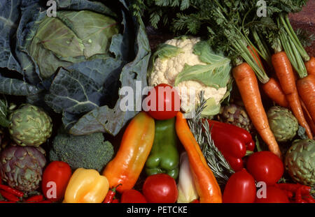 Assorted harvested fresh vegetables including carrots, cabbage, cauliflower, globe artichokes, capsicums and tomatoes. Stock Photo