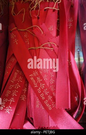 Wish ribbons in chinese buddhist Kek lok Si temple, Malaysia. Chinese and english word of Family to be Safe on the ribbon Stock Photo