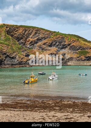 Fishing boats anchored in a the bay at Port Isaac in Cornwall on a summer’s day Stock Photo