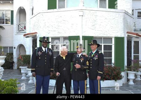 Capt. Elias Isreal (left), commander, Troop C, 3rd Cavalry Regiment, Lt. Col. Jason Davis (right), commander, Tiger Squadron, 3rd CR, and retired Command Sgt. Maj. Harvey Reed (second from right), executive director of the 3rd Cav. Association, stand outside of retired Brig. Gen. Albin Irzyk’s (second from left) home in West Palm Beach, Fla., Jan. 24. Irzyk had Isreal’s position as Charlie Troop’s commander 76 years ago. (U.S. Army photo taken by Maj. Vance Trenkel, 3d Cavalry Regiment Public Affairs) Stock Photo