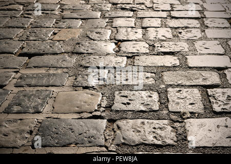 Cobblestone street surface closeup backlit Stock Photo