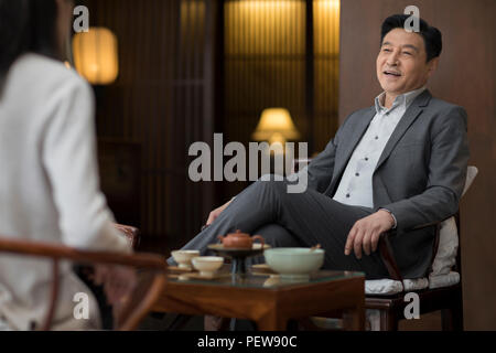 Cheerful businessman drinking tea Stock Photo