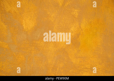 Old stucco plaster yellow painted wall abstract background Stock Photo