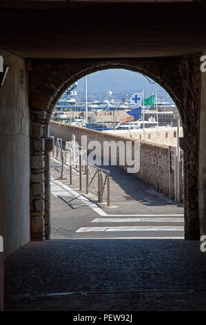 A low angle shot of a narrow street between old houses in Scalea ...
