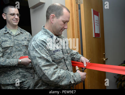 Col. Gentry Boswell, 28th Bomb Wing commander, cuts the ribbon during the 2016 Tax Center grand opening at Ellsworth Air Force Base, S.D., Jan. 28, 2016. The Tax Center is located in suite 1300 of the Rushmore Center – personnel will be assisted on an “appointment only” basis. (U.S. Air Force photo by Airman Donald Knechtel/Released) Stock Photo