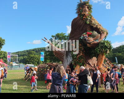 Impressive Green Man sculpture built by Pyrite Creative for the Green Man festival held in Wales. Family taking selfie in front of the Green Man. Stock Photo